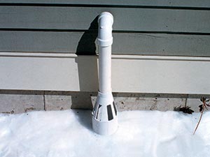 IceGuard® device covering a snowy sump pump discharge hose