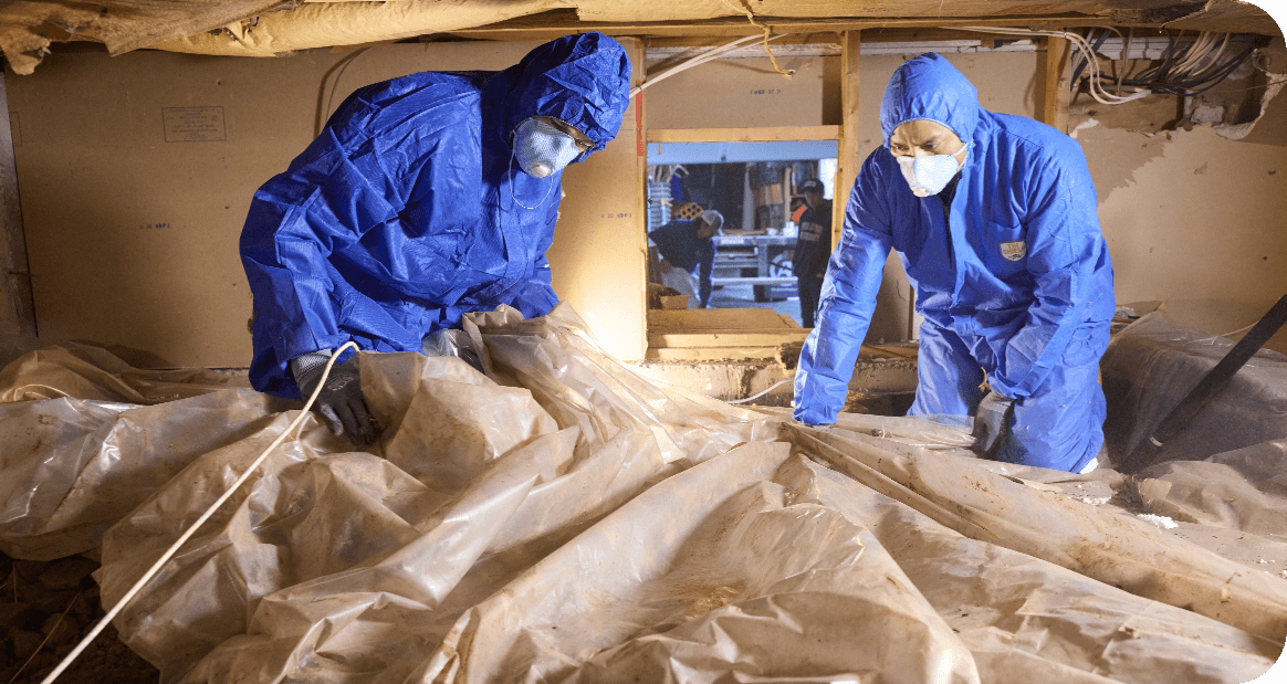 Foundation repair specialist working on crawl space drainage