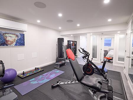 Living space and home gym in a finished basement