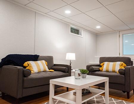 Carefully planned lighting is essential for any finished basement. Use a combination of recessed can and recessed fluorescent fixtures to maintain headroom. Use separate circuits and dimmers where possible for versatility.