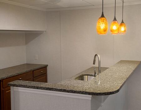 The use of decorative fixtures and accent lights, combined with mirrors, will make your finished basement look more like &ldquo;upstairs&rdquo; rooms.