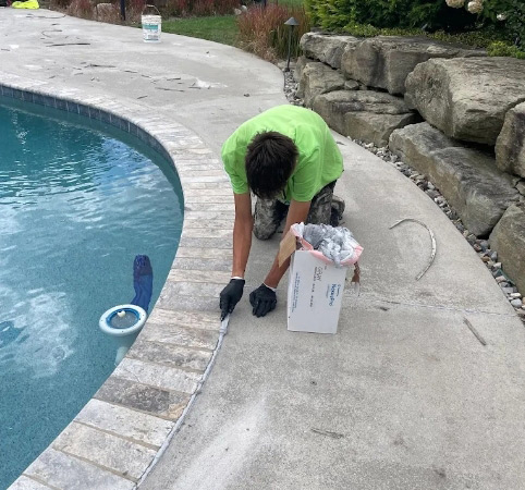 Foamworks technician working on pool deck concrete