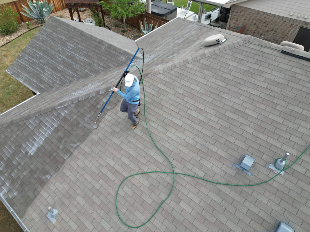 FreshRoof roof rejuvenation treatment being applied to a roof in Texas Hill Country