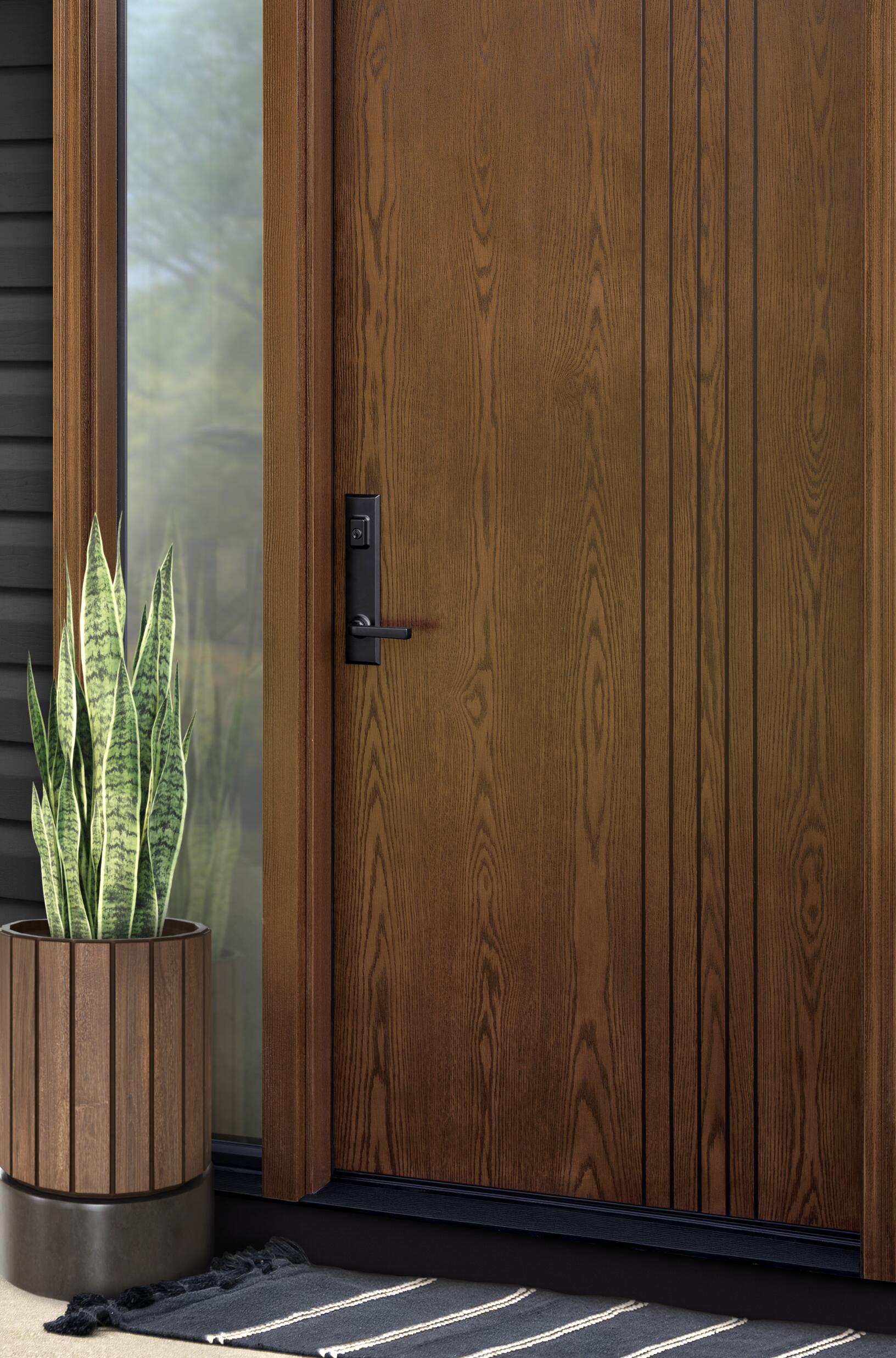 Ascent woodgrain door in Aged Barrel with a glass sidelite and black Westcott handle