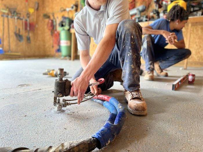 Concrete leveling crew performing polyurethane foam concrete repair