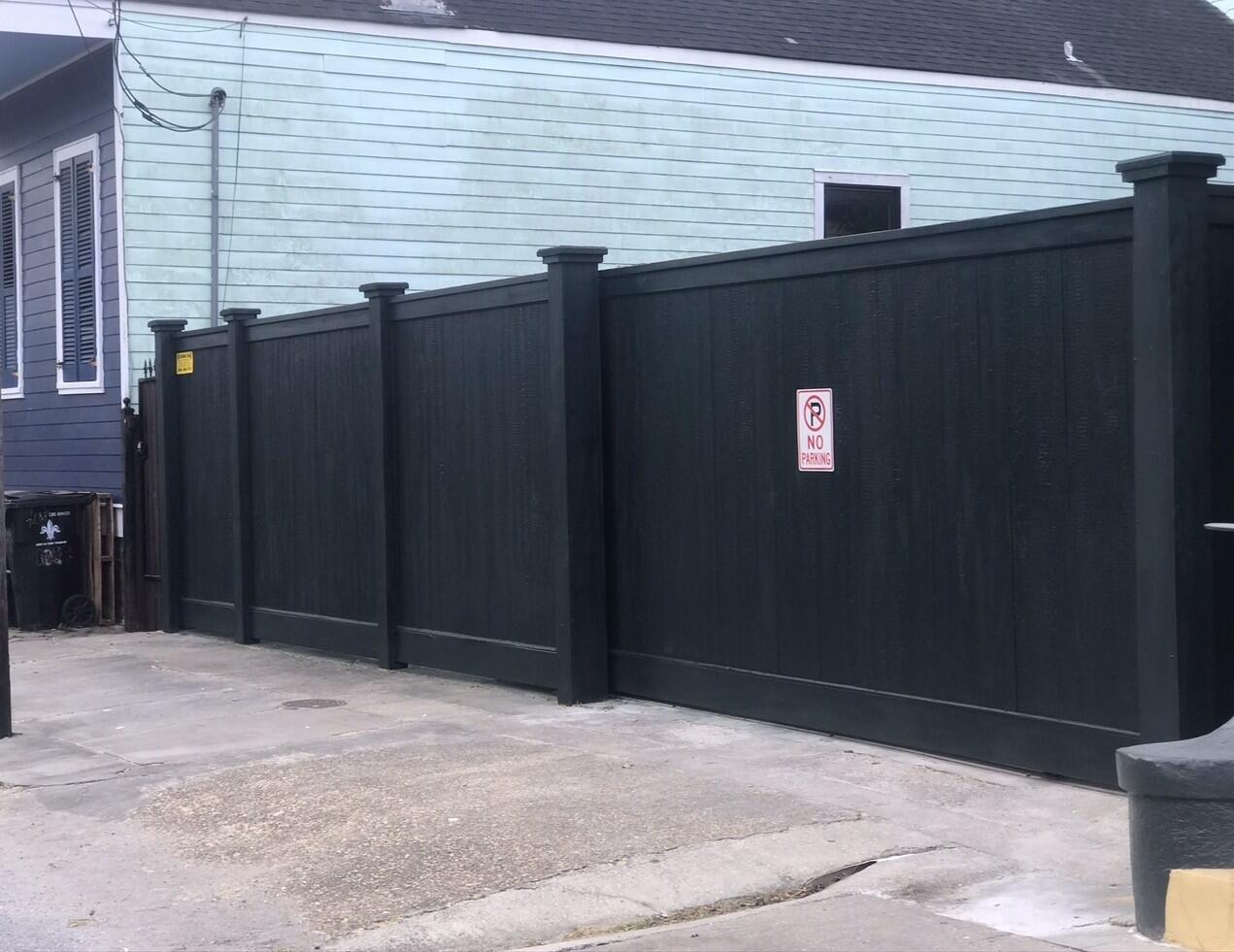 Black composite fence installation in Metairie, Louisiana