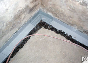 Installation in progress of a perimeter basement drain system