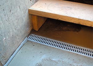 a hatchway entrance protected from flooding by our TrenchDrain basement drainage system.