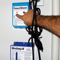 A set of sump pump alarms installed in a basement