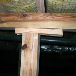 a crawl space support post repaired by adding shimming