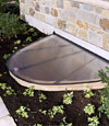 A beautiful egress window well installed on a finished basement living room area.