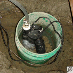 A sump pump installed in a small five gallon bucket.