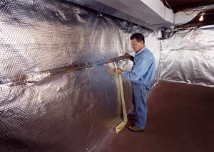 A radiant heat barrier and vapor barrier system installation in progress by one of the contractors employed by a Basement Systems Dealer