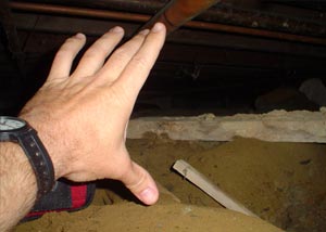 A crawl space that's so narrow that it's not a hand's width tall.