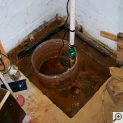 An ugly sump pump system flooded with water and looking disgusting.