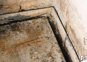 an ugly weeping tile system installed in a basement.