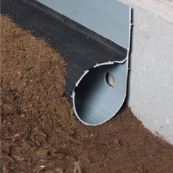 A drainage system installed along the interior perimeter of the crawl space