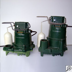 Two cast-iron Zoeller sump pump systems.