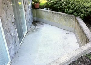 A concrete patio surface about to be specially cleaned and protected with our concrete coating product.