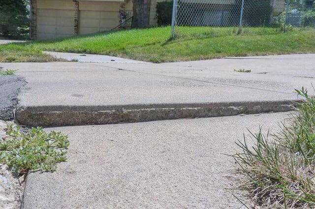 Sinking uneven concrete sidewalk