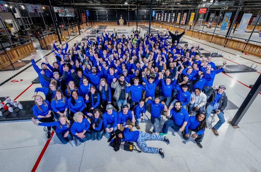 Group photo of people in blue shirts