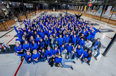 Group photo of people in blue shirts