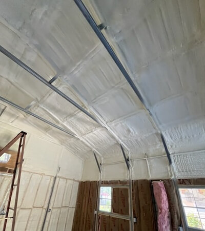 Spray foam applied to ceiling and walls in commercial building