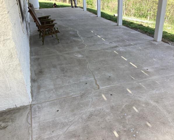 Patio slab lifted back to level with the holes patched after foam leveling