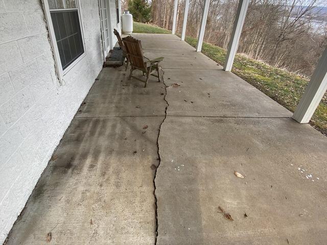 Settled patio slab separating and dropping along the seam before leveling