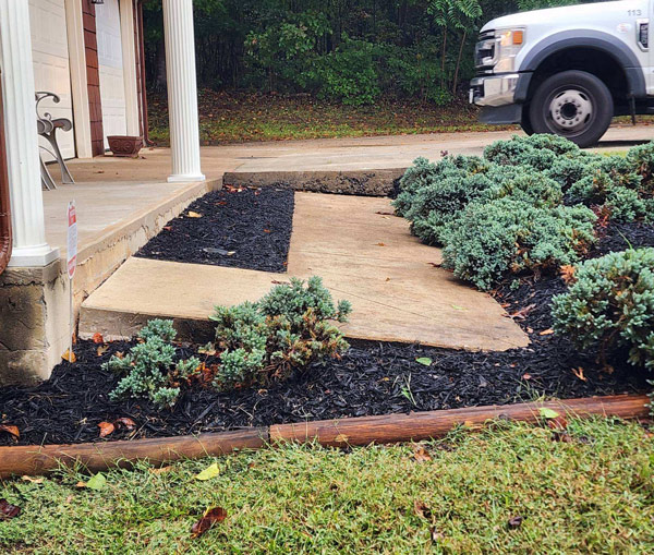 Settled and tilted concrete walkway pulling away from a Chicagoland front porch