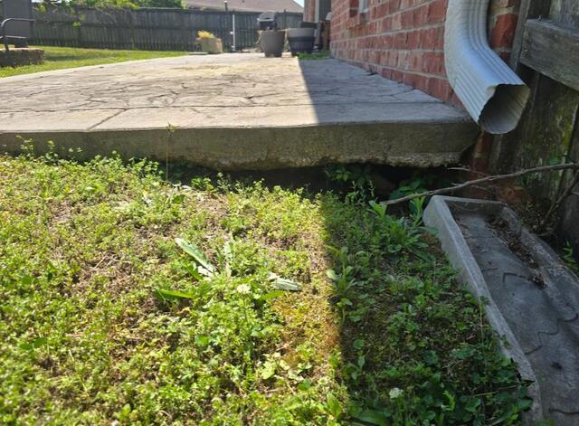 Fixing Back Patio Erosion in Pearl, MS - Before Photo