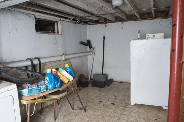 Damp Cluttered Basement in Medford NY - Before Photo