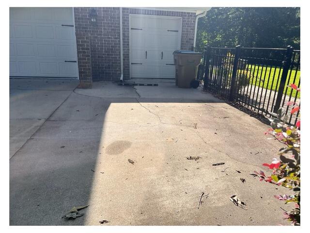 Sealing Cracked and Uneven Concrete Driveway in Richmond Hill, GA - Before Photo