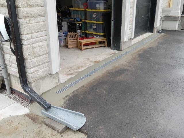Add Large trench drain in front of garage in Oakville, On - After Photo