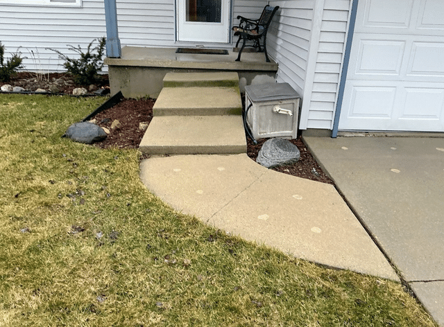Sunken Unsafe Concrete Driveway Repaired Using Poly Level Foam in Menasha, WI - Before Photo