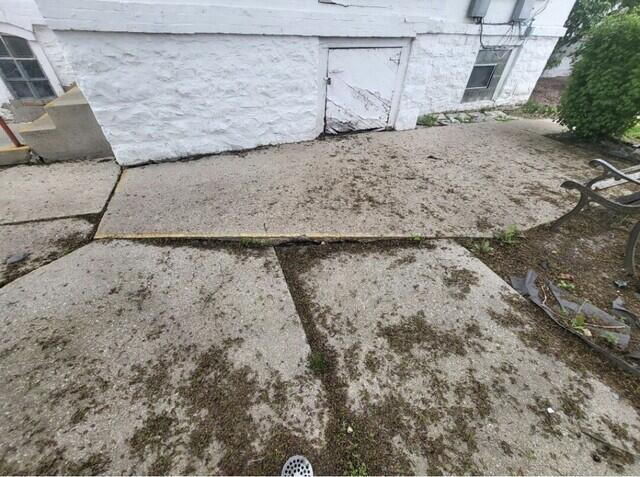 Sunk & Uneven Concrete Patio Repair in Fond Du Lac, WI - Before Photo