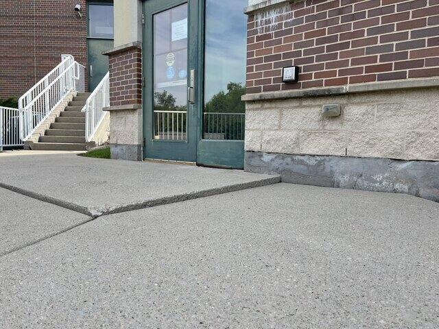 Sunk & Uneven Concrete Sidewalk Leveled & Repaired in Green Bay, WI - Before Photo