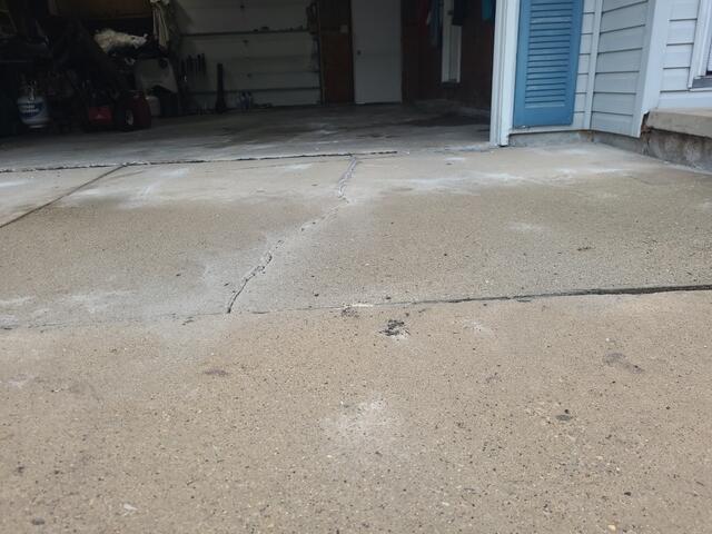 Severely Cracked and Sunken Concrete Driveway Repaired & Sealed in Green Bay, WI - After Photo