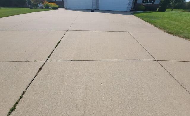 Concrete Driveway Repaired & Joints Sealed in Combined Locks, WI - Before Photo