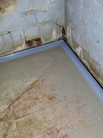 Wet Basement With Extreme Water Seepage Has Sump Pump System Installed In Wautoma, WI - After Photo