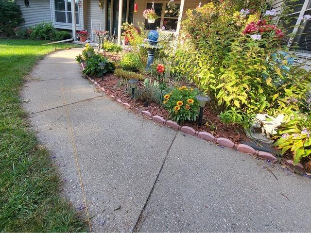 Cracked, Uneven Concrete Lifted and Cracks Sealed in Wautoma, WI - Before Photo