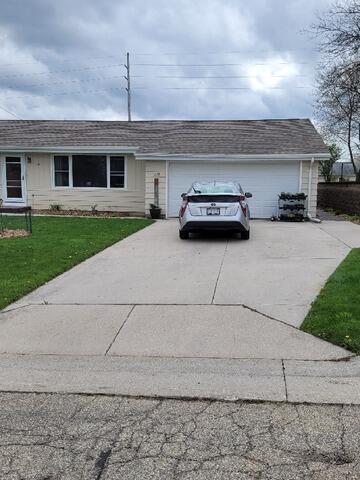 Uneven, Cracked Concrete Driveway Leveled & Stabilized In Plymouth, WI - Before Photo