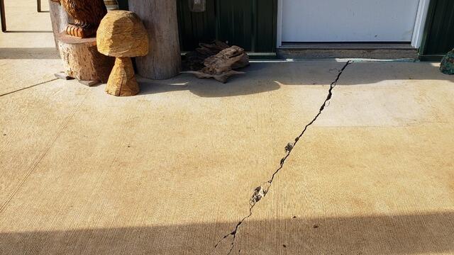 Concrete Patio Cracks Evened Out & Sealed in Elton, WI - Before Photo