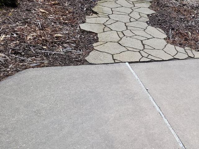 Concrete leveling company, Sure-Dry, removes trip hazards in Pine River, WI - Before Photo