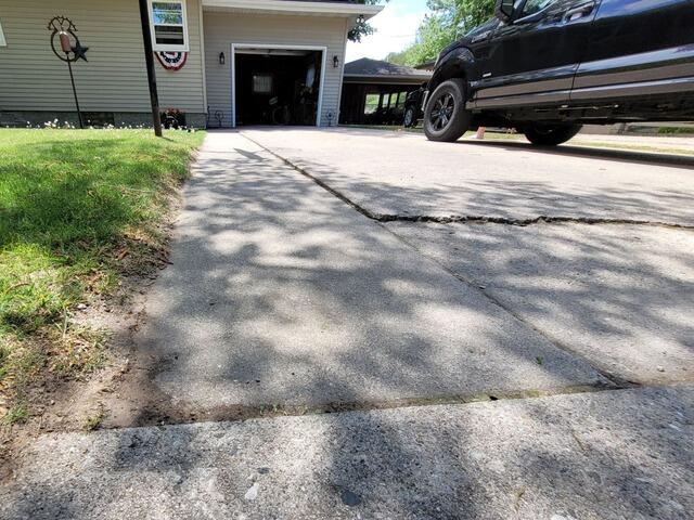 Cracked and Sunken Concrete Driveway Repaired in Marinette, WI - Before Photo