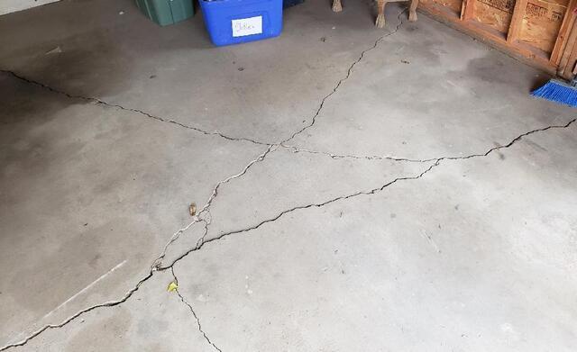 Concrete Garage Leveled with PolyLevel in Manawa, WI - Before Photo