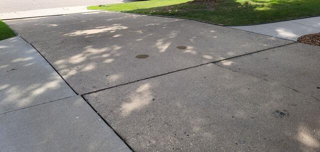 Sunken Concrete Driveway Lifted, Leveled & Repaired in Mayville, WI - Before Photo
