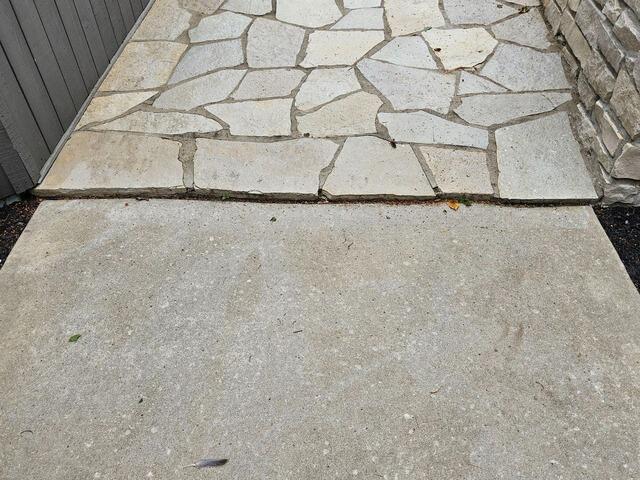 Settling Concrete Sidewalk Lifted & Sealed in Crivitz, WI - Before Photo