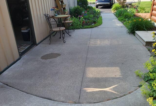 Uneven Concrete Patio & Adjoining Sidewalk Repaired in Crivitz, WI - Before Photo