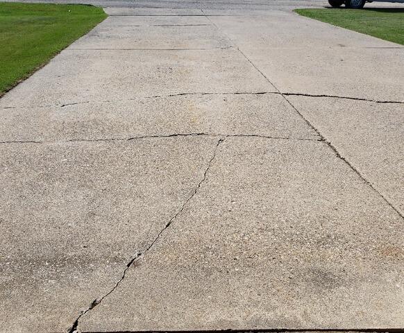 Concrete Driveway and Garage Floor Lifted, Leveled, and Sealed in Stephenson, MI - Before Photo